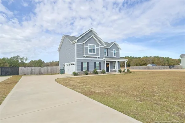 a front view of a house with a yard and balcony