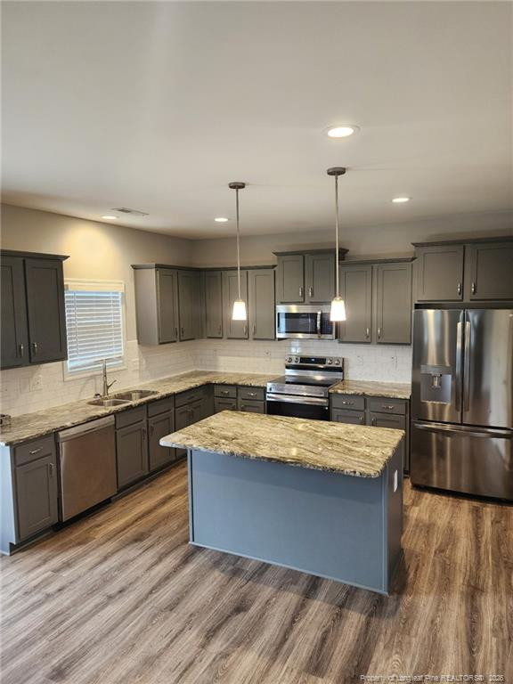 7810 Rufus Johnson Road St. Pauls, NC 28384 - Photo 11 of 27 a large kitchen with a large counter top a sink stainless steel appliances and cabinets