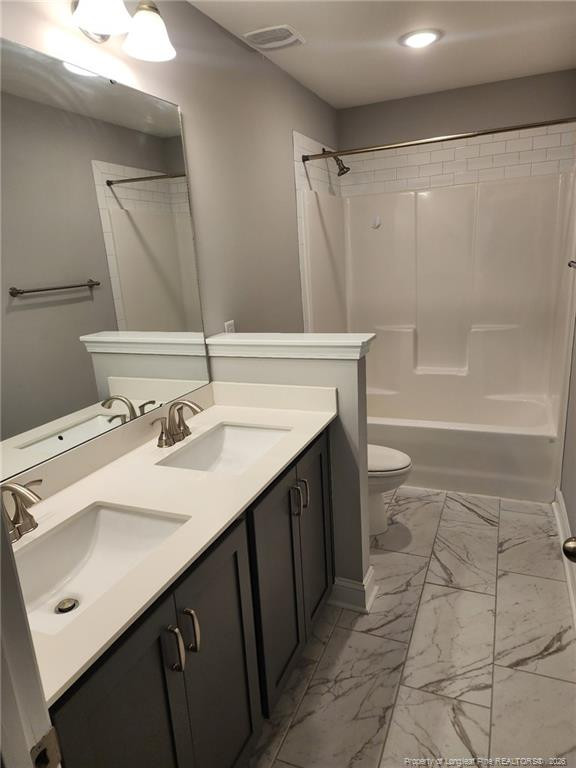 7810 Rufus Johnson Road St. Pauls, NC 28384 - Photo 16 of 27 a bathroom with a sink a toilet a mirror and shower