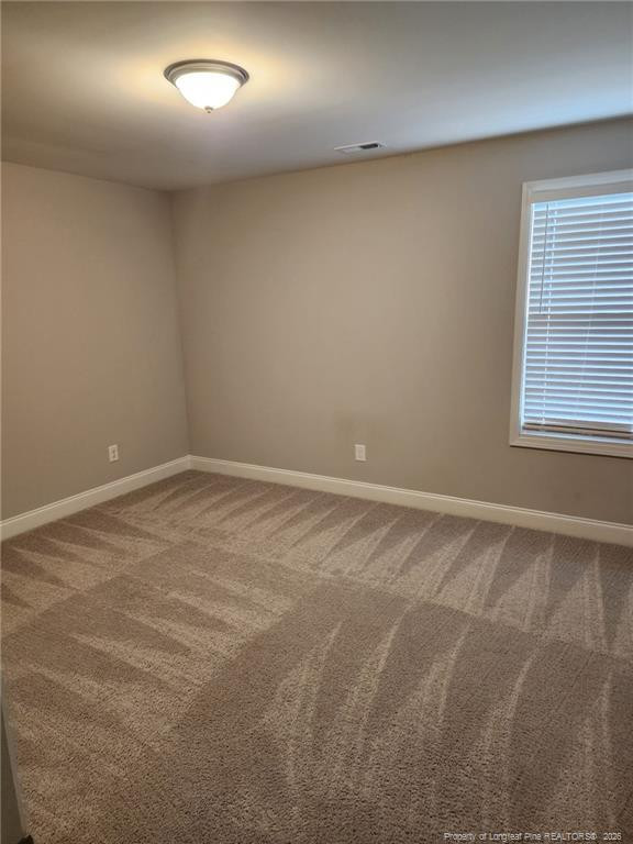 7810 Rufus Johnson Road St. Pauls, NC 28384 - Photo 18 of 27 an empty room with a window