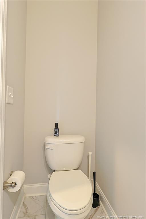 7810 Rufus Johnson Road St. Pauls, NC 28384 - Photo 19 of 24 a white toilet sitting next to a white sink