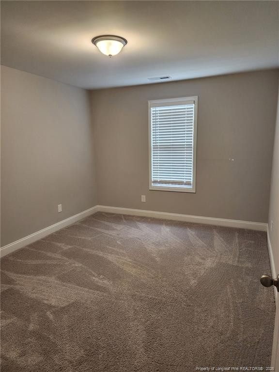 7810 Rufus Johnson Road St. Pauls, NC 28384 - Photo 20 of 27 a view of an empty room with a window