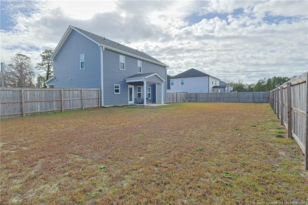7810 Rufus Johnson Road St. Pauls, NC 28384 - Photo 22 of 24 a view of a house with a yard and large tree