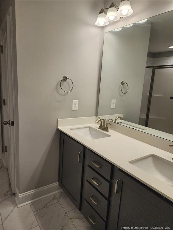 7810 Rufus Johnson Road St. Pauls, NC 28384 - Photo 22 of 27 a bathroom with a sink a light fixture and a mirror