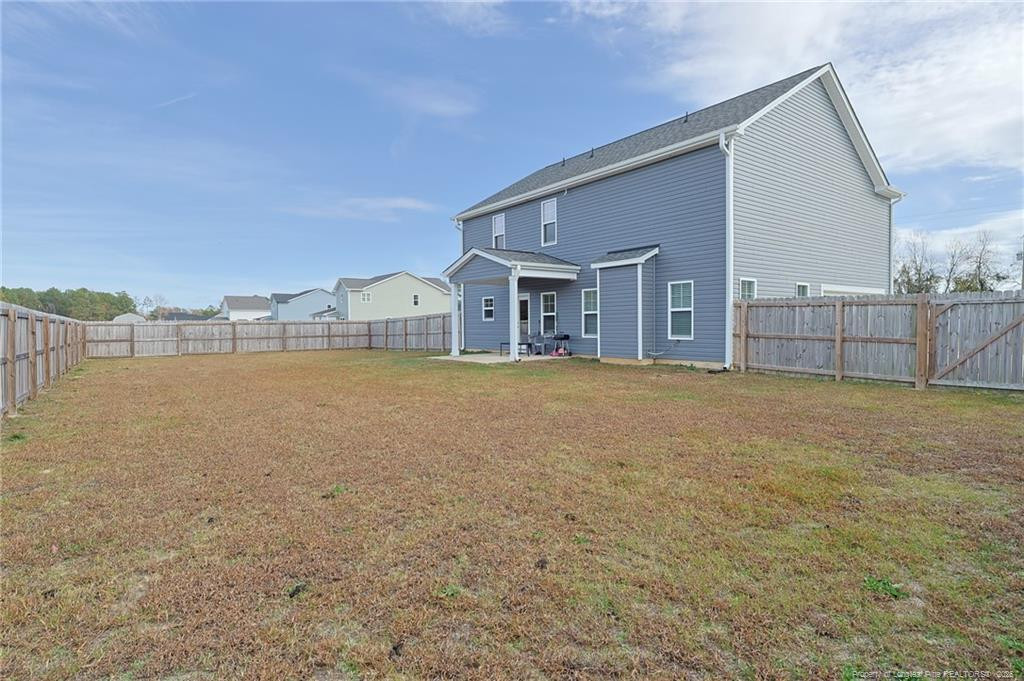 7810 Rufus Johnson Road St. Pauls, NC 28384 - Photo 7 of 27 a view of a house with a outdoor space