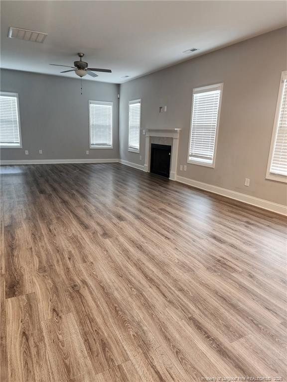 7810 Rufus Johnson Road St. Pauls, NC 28384 - Photo 10 of 27 an empty room with wooden floor fireplace and windows
