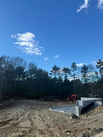 a view of a backyard with furniture and a garden