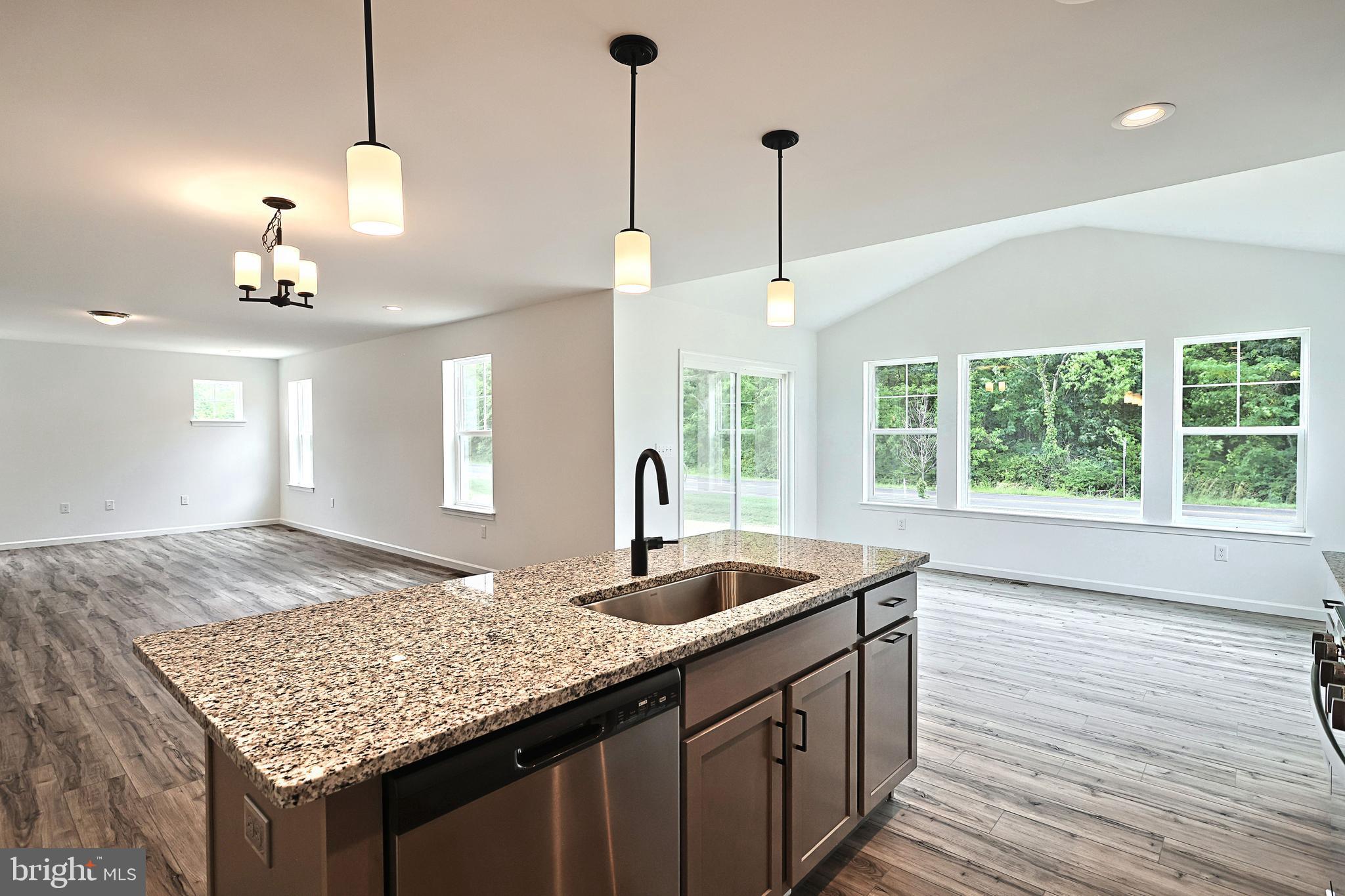 Emily Plan At Hickory Pointe Waynesboro, PA 17268 - Photo 13 of 22 a kitchen with center island wooden floor and a chandelier