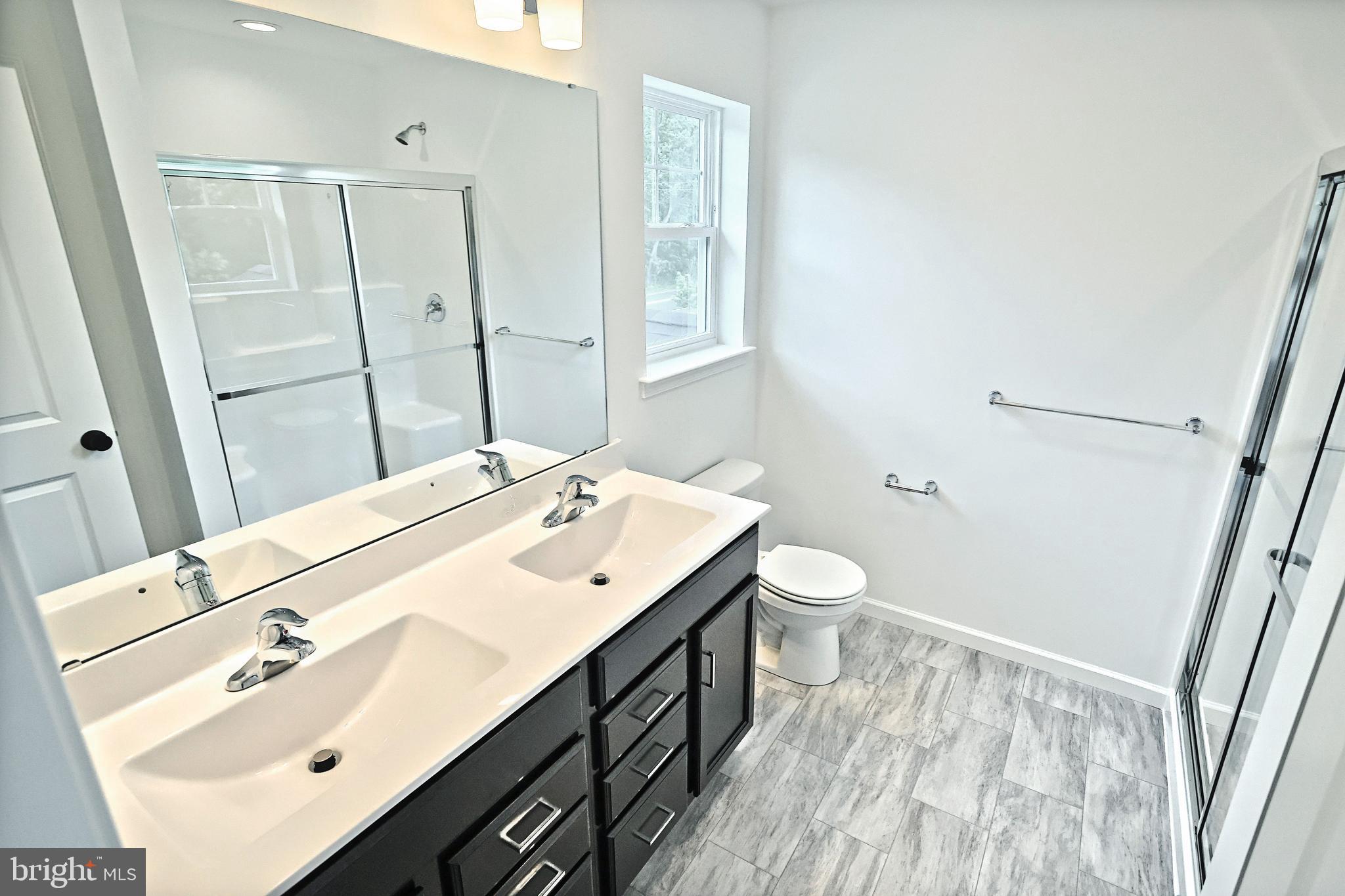 Emily Plan At Hickory Pointe Waynesboro, PA 17268 - Photo 16 of 22 a bathroom with a double vanity sink toilet and mirror