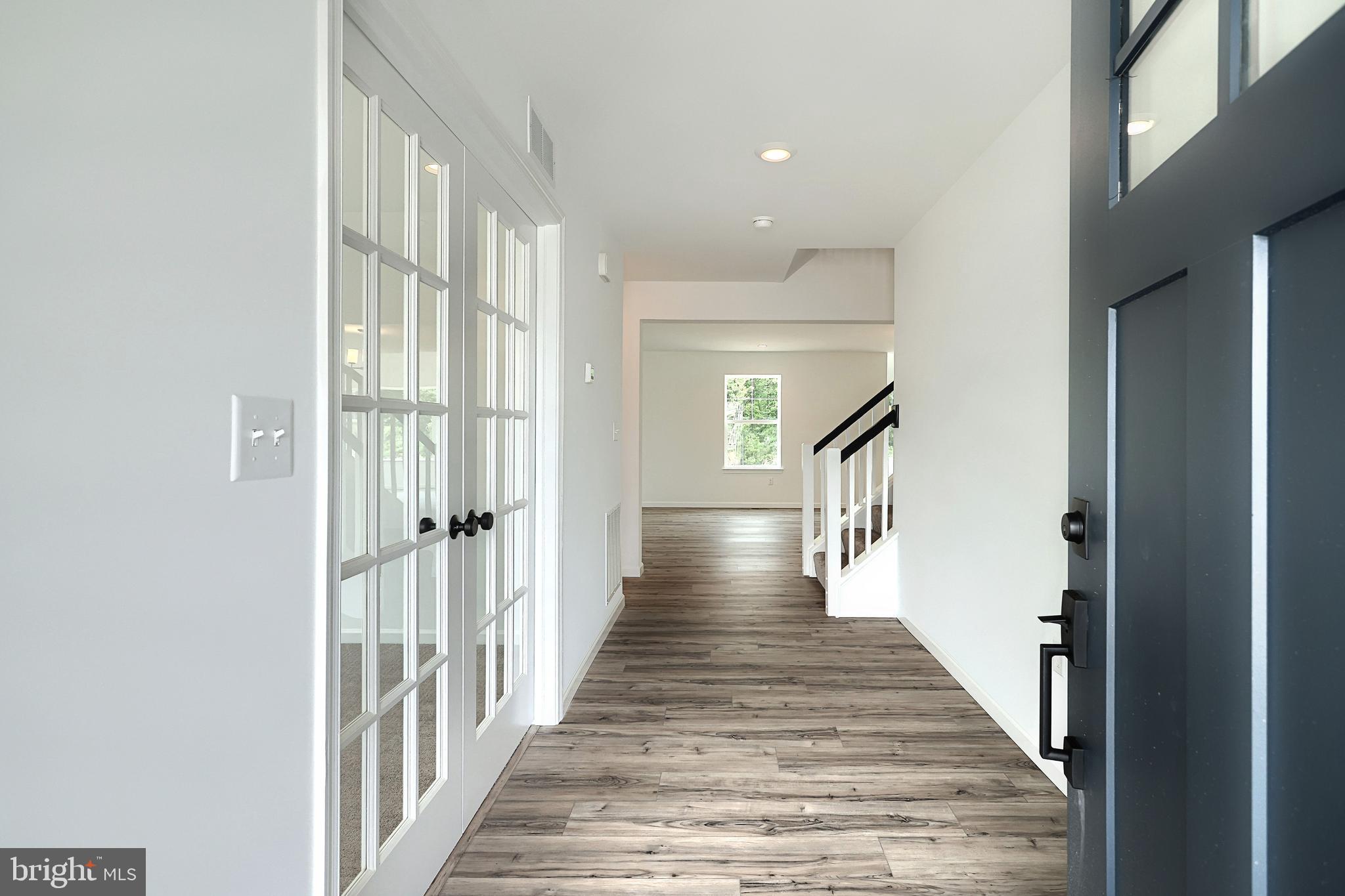 Emily Plan At Hickory Pointe Waynesboro, PA 17268 - Photo 2 of 22 a view of a hallway with wooden floor and staircase