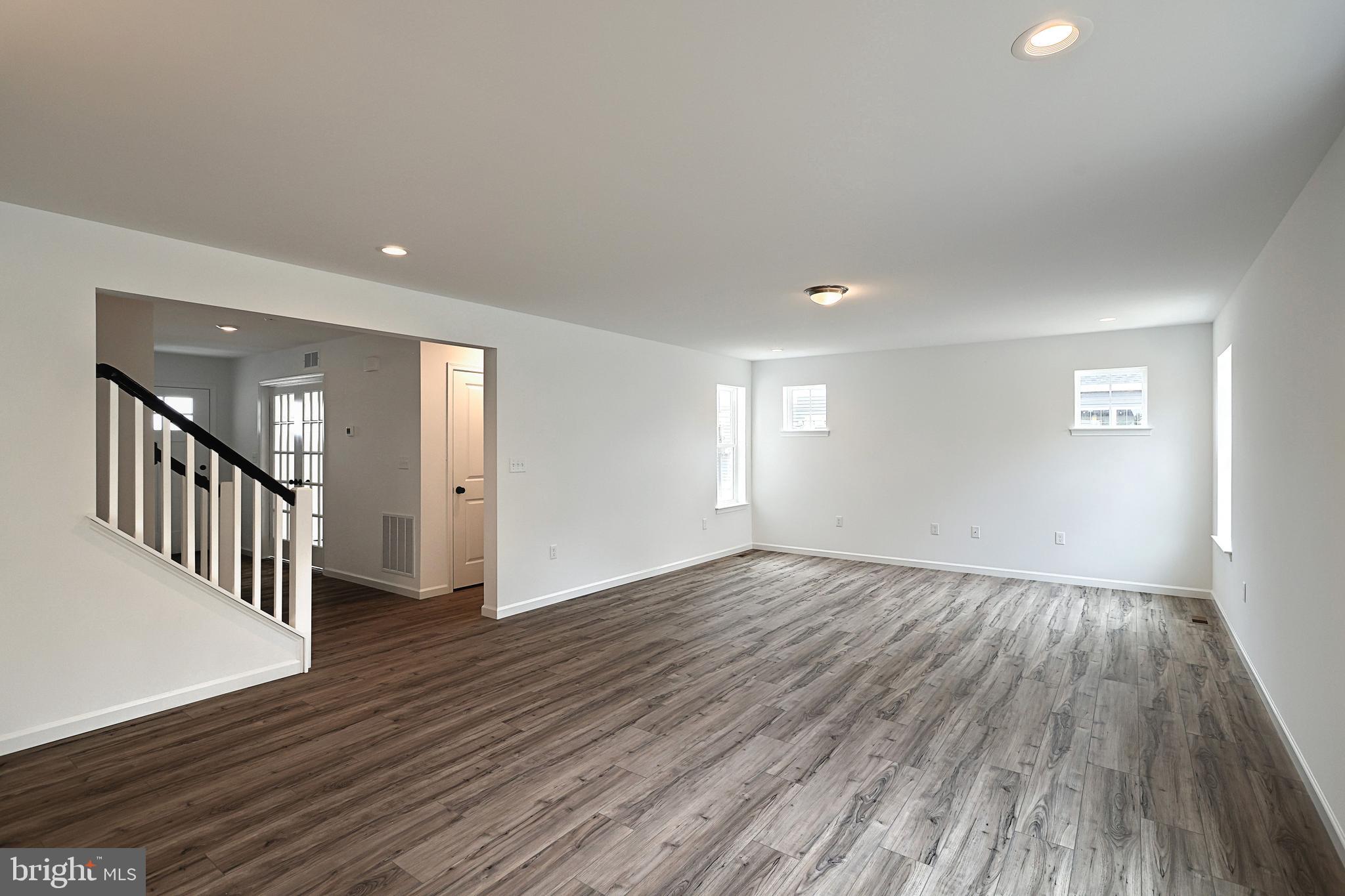Emily Plan At Hickory Pointe Waynesboro, PA 17268 - Photo 8 of 22 a view of an empty room with wooden floor and windows