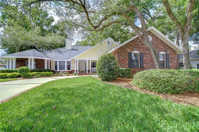 a front view of a house with yard and green space