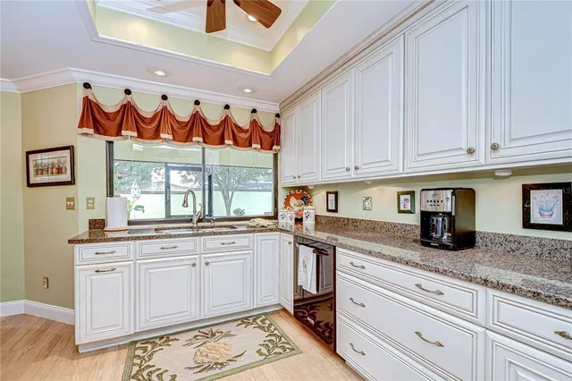 a kitchen with stainless steel appliances granite countertop a sink and cabinets