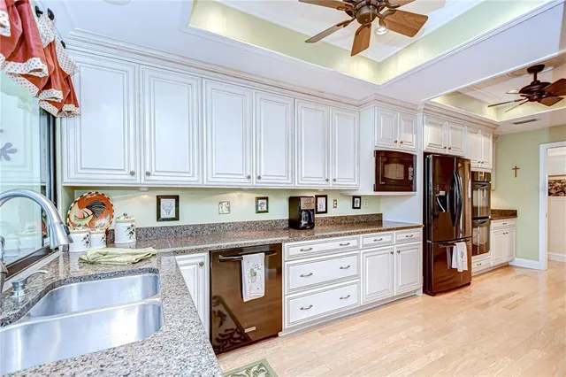 a kitchen with stainless steel appliances granite countertop a sink and cabinets