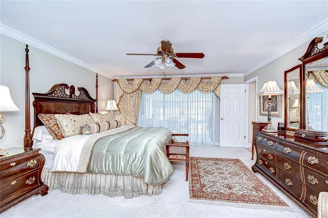 a bedroom with a bed and dresser with mirror