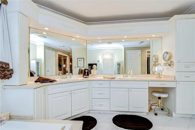 a spacious bathroom with a sink a toilet a mirror and vanity