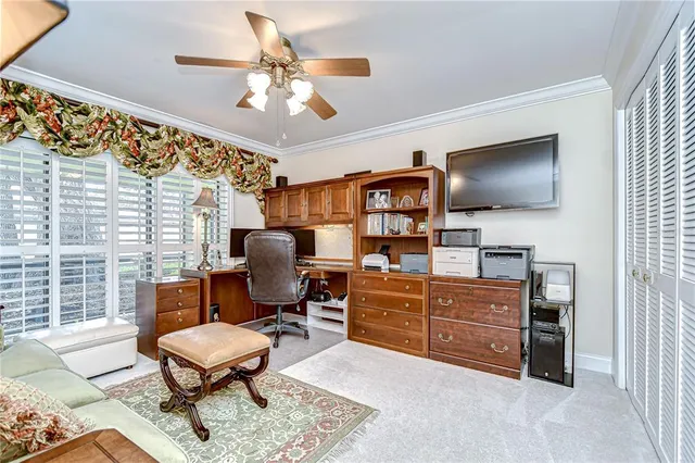 a work room with furniture and a flat screen tv