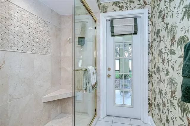 a bathroom with a glass door shower and a sink
