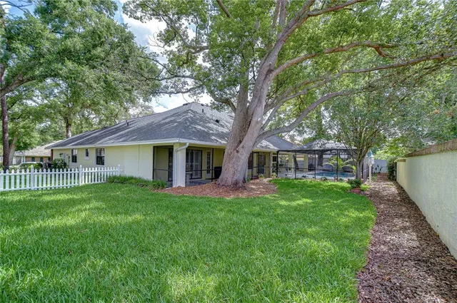 a front view of a house with a garden and trees