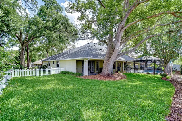 a front view of a house with a yard and trees