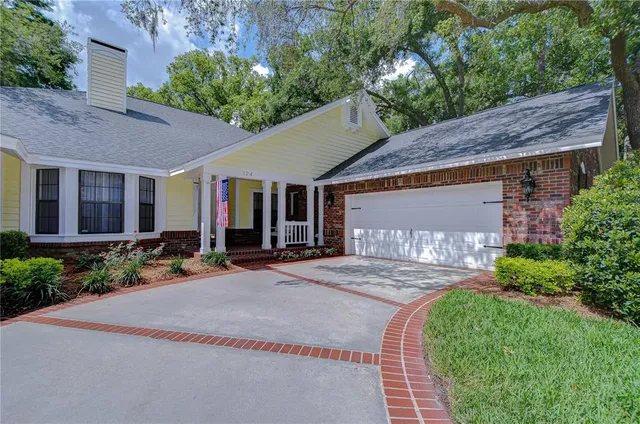 a front view of a house with garden and patio