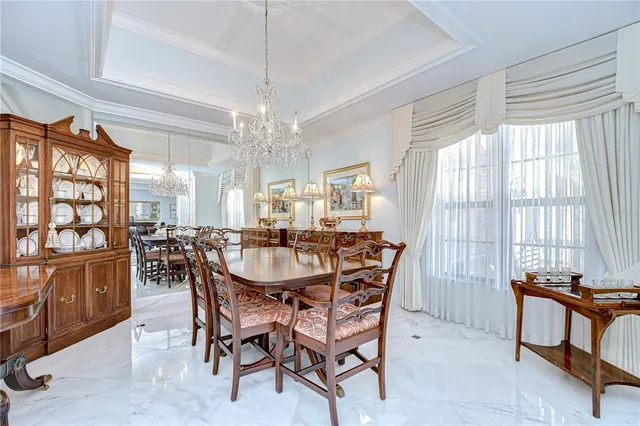 a view of a dining room with furniture and a chandelier