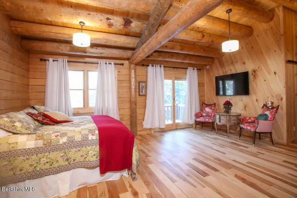 a bed room with a bed and a television