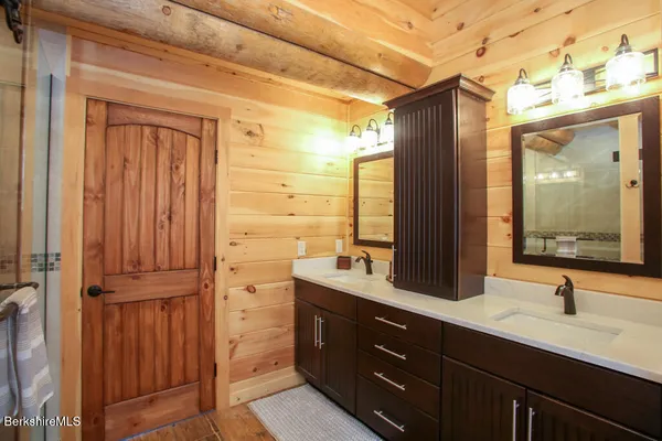 a bathroom with a double vanity sink and mirror