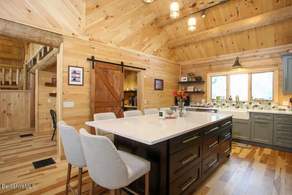 a large kitchen with a table and chairs