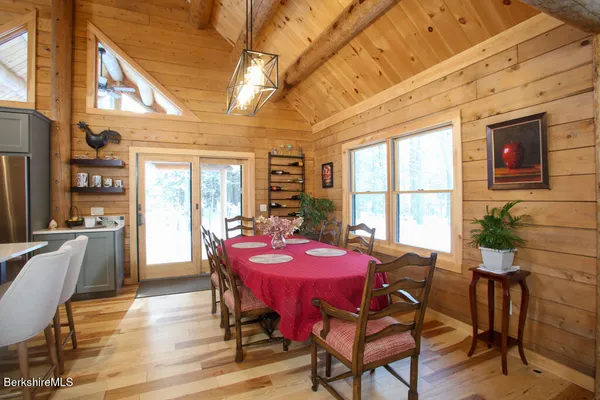 a dining room with furniture window and wooden floor