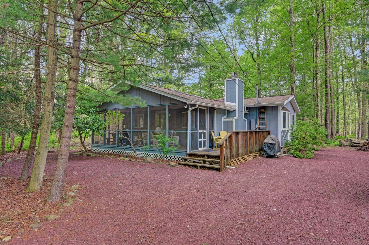 a view of a house with backyard porch and sitting area