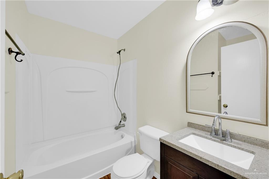 4200 Linda Vista Street Pharr, TX 78577 - Photo 11 of 17 a bathroom with a granite countertop sink toilet and shower