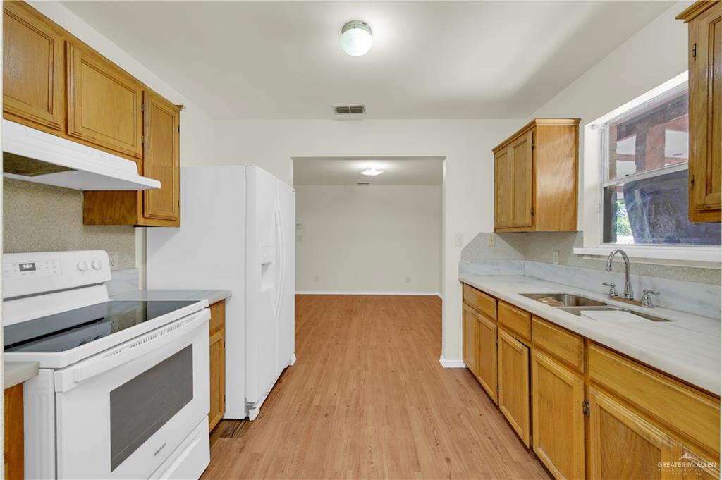 4200 Linda Vista Street Pharr, TX 78577 - Photo 5 of 17 a kitchen with a sink stove and cabinets