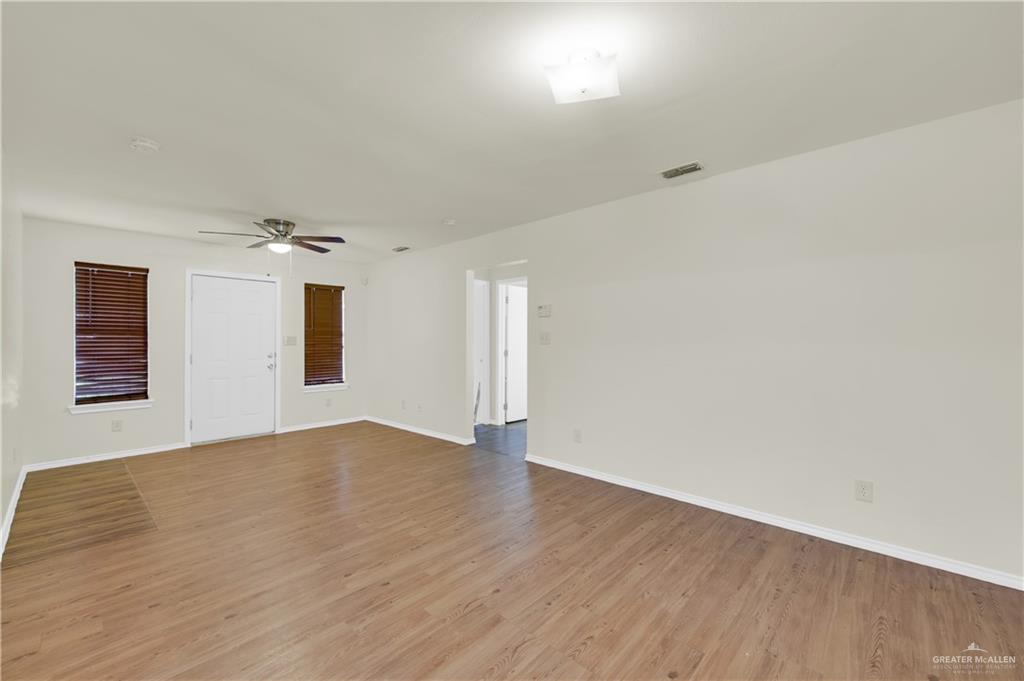 4200 Linda Vista Street Pharr, TX 78577 - Photo 8 of 17 an empty room with wooden floor and windows