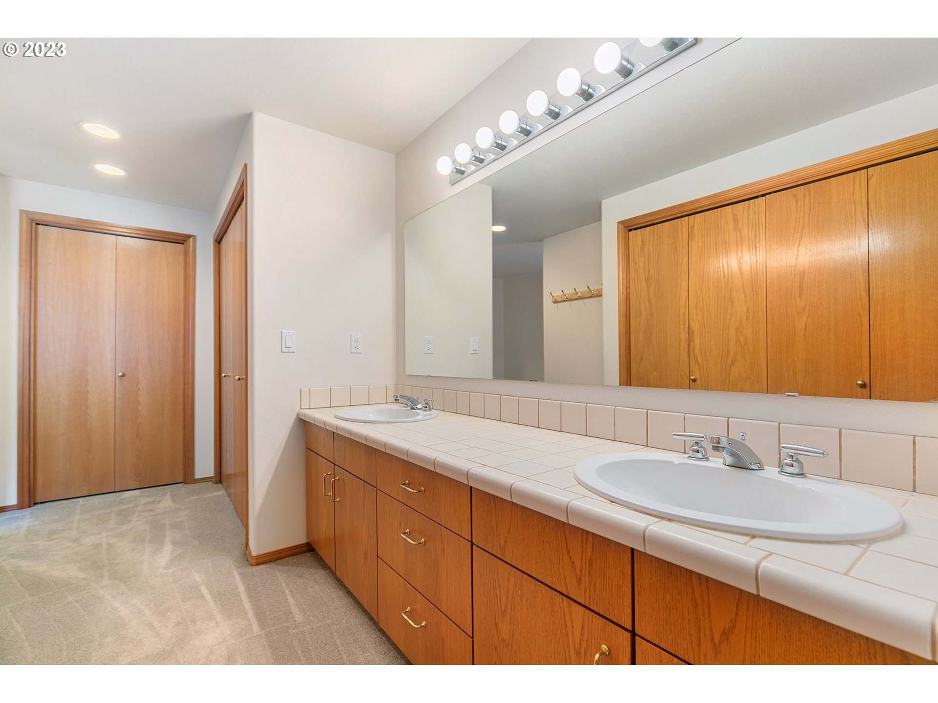 2217 Northeast 179th Street, Unit E10 Ridgefield, WA 98642 - Photo 11 of 23 a bathroom with a sink double vanity and a mirror