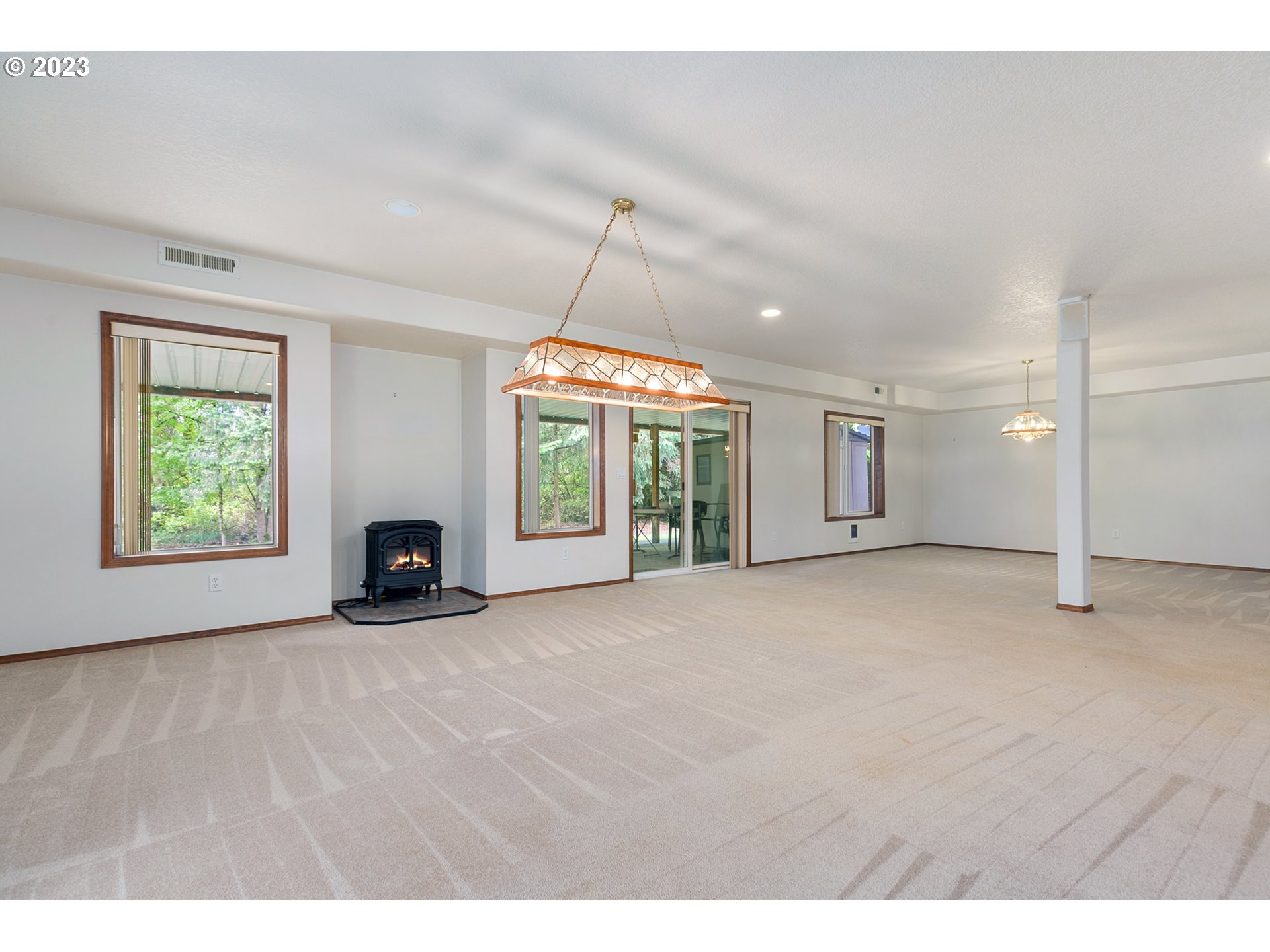 2217 Northeast 179th Street, Unit E10 Ridgefield, WA 98642 - Photo 16 of 23 a view of an empty room with a fireplace and a window