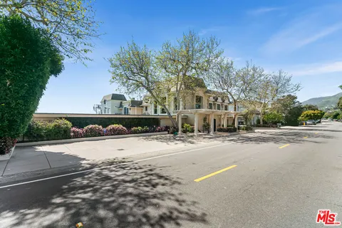 a front view of a house with a potted plant