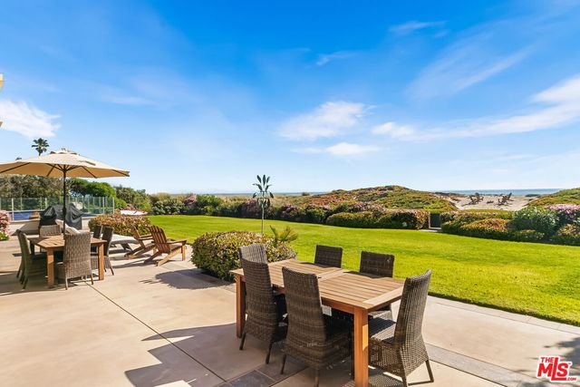 a view of a ocean with couches and city view