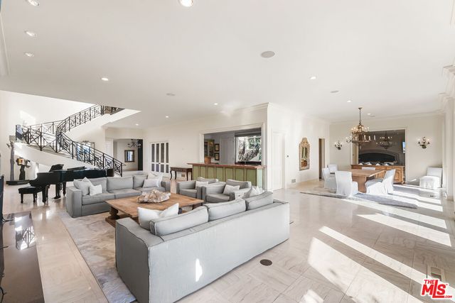 a view of a patio with a dining table and chairs potted plants with sky view