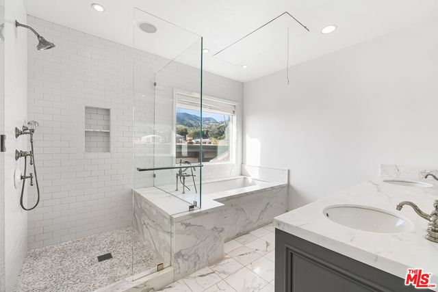 a bedroom with a large bed and a large window