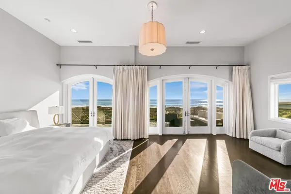 an aerial view of a house with a ocean
