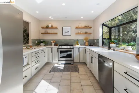 a kitchen with a sink window and cabinets