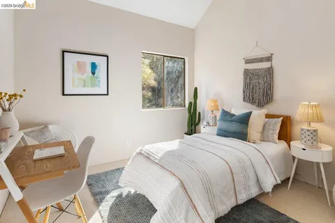 a bedroom with bed and a chair