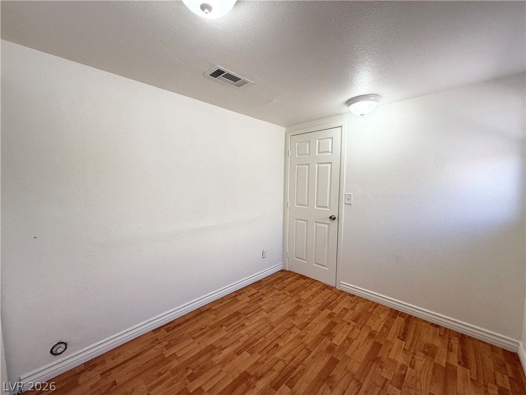 616 Greenway Road Henderson, NV 89002 - Photo 11 of 32 Rich hardwood-style flooring extends across this room, offering a neutral backdrop for customization.