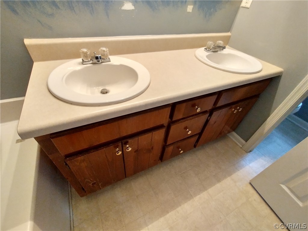 5929 Trinity Church Road Church Road, VA 23833 - Photo 12 of 26 a bathroom with a double vanity sink and a mirror