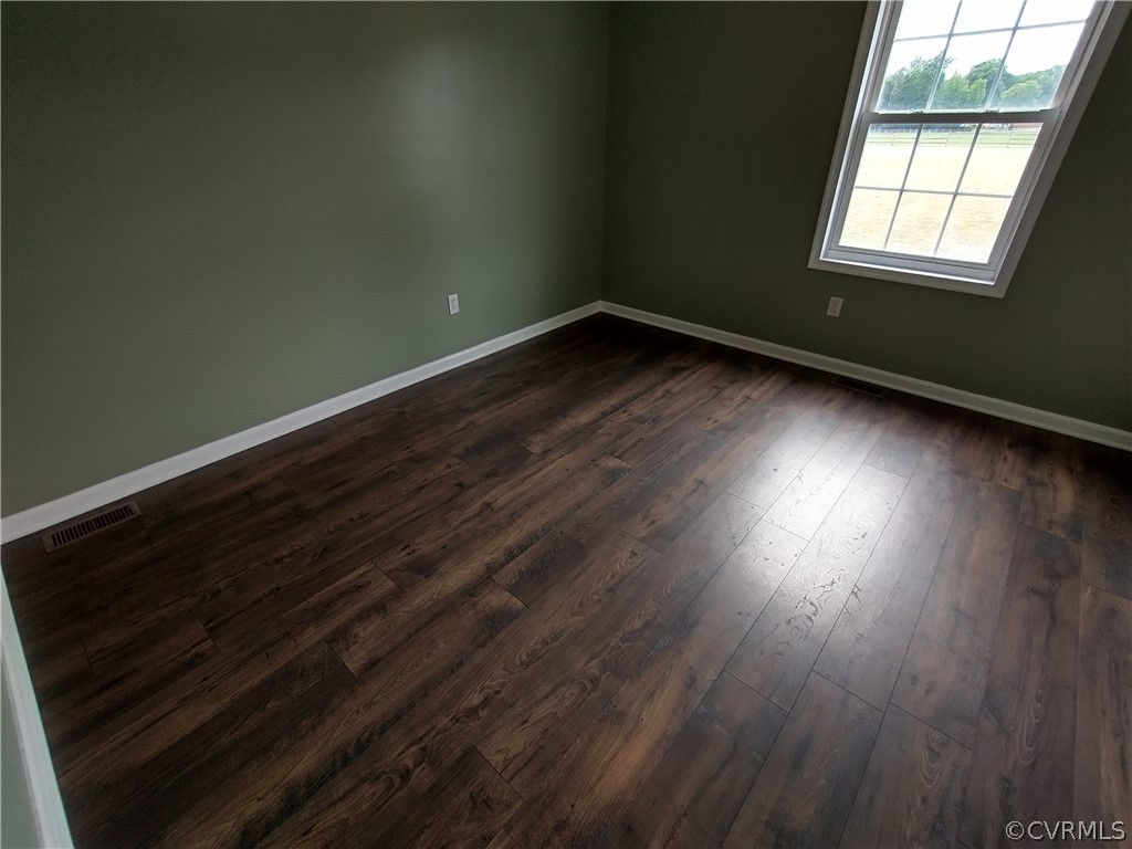 5929 Trinity Church Road Church Road, VA 23833 - Photo 17 of 26 an empty room with wooden floor and windows
