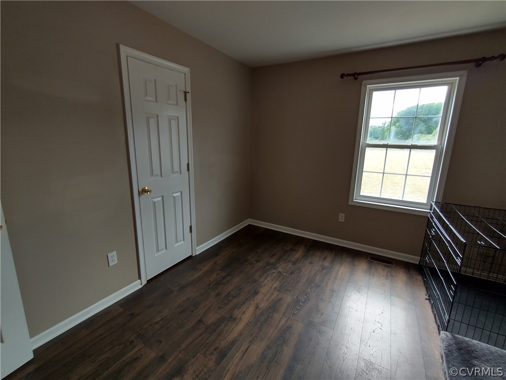 5929 Trinity Church Road Church Road, VA 23833 - Photo 20 of 26 an empty room with wooden floor and windows