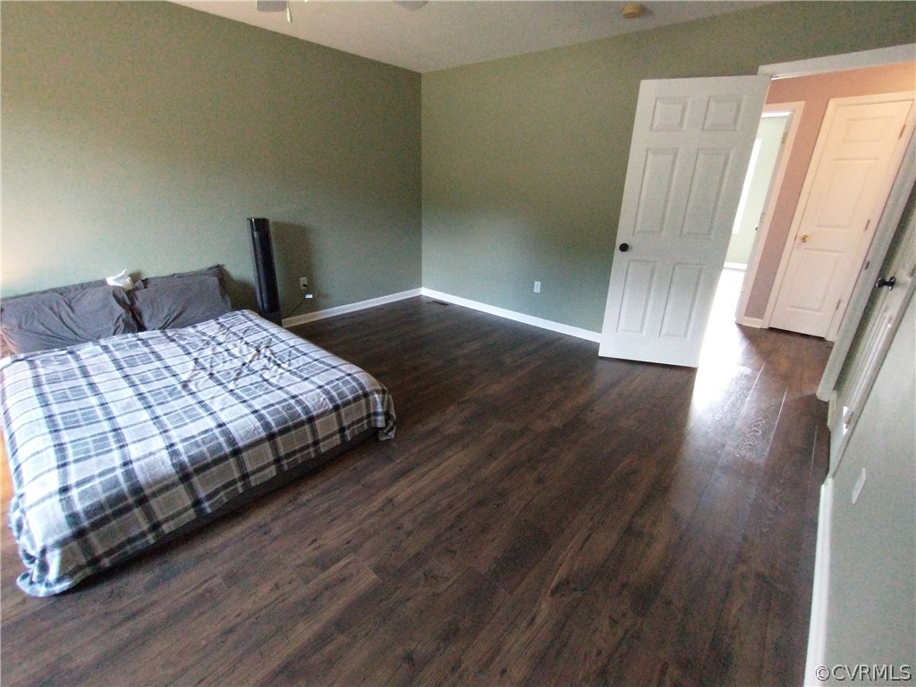 5929 Trinity Church Road Church Road, VA 23833 - Photo 9 of 26 a bedroom with a bed and wooden floor