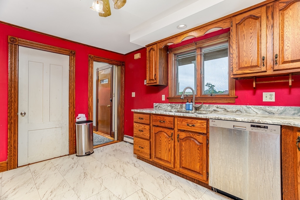54 Charles Street Gardner, MA 01440 - Photo 9 of 40 a bathroom with a granite countertop sink and a mirror