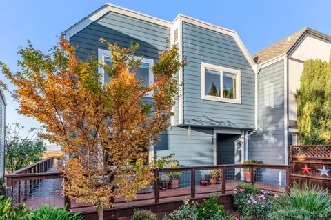 front view of a house with a tree